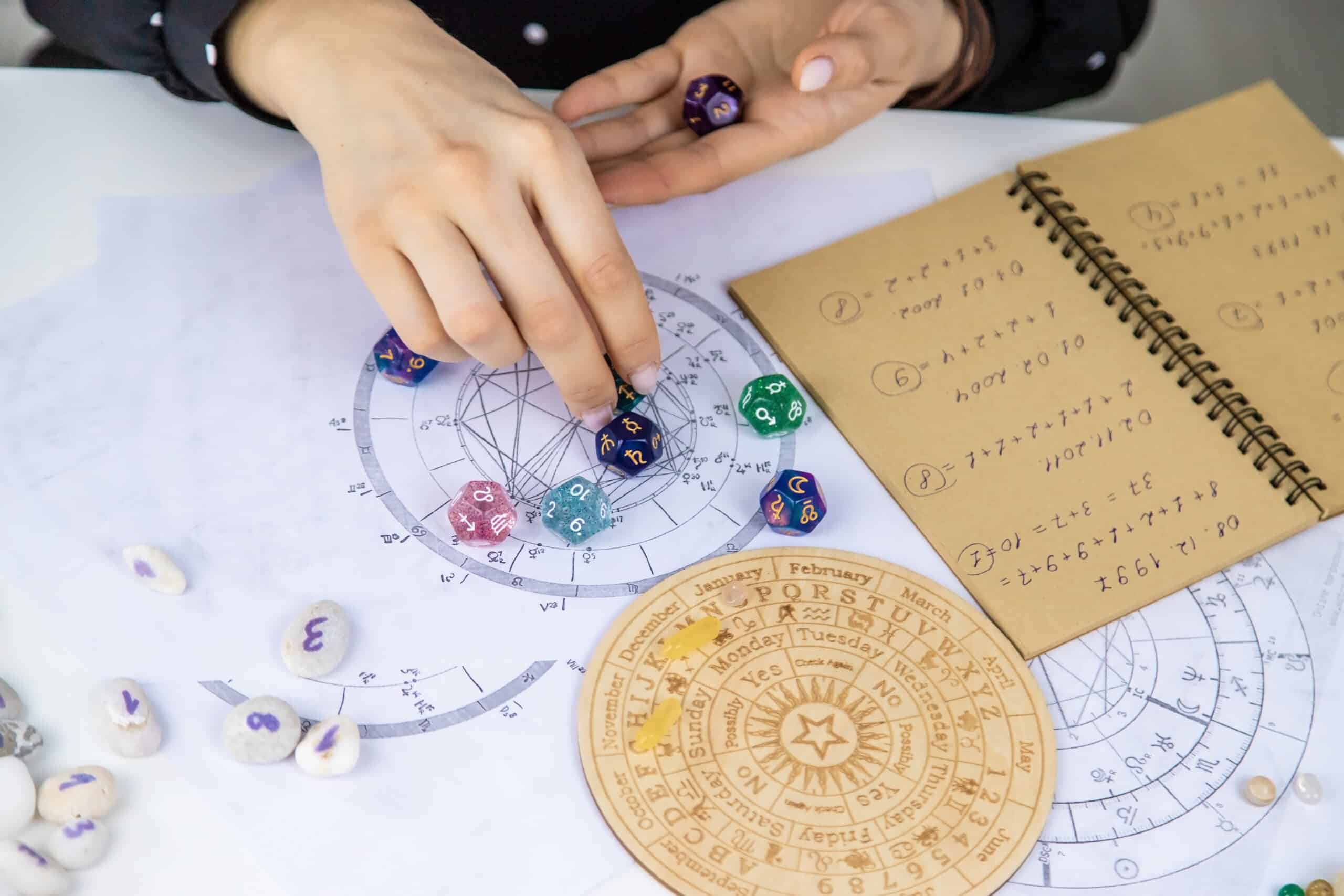 Woman numerologist astrologer counts numbers. Selective focus.